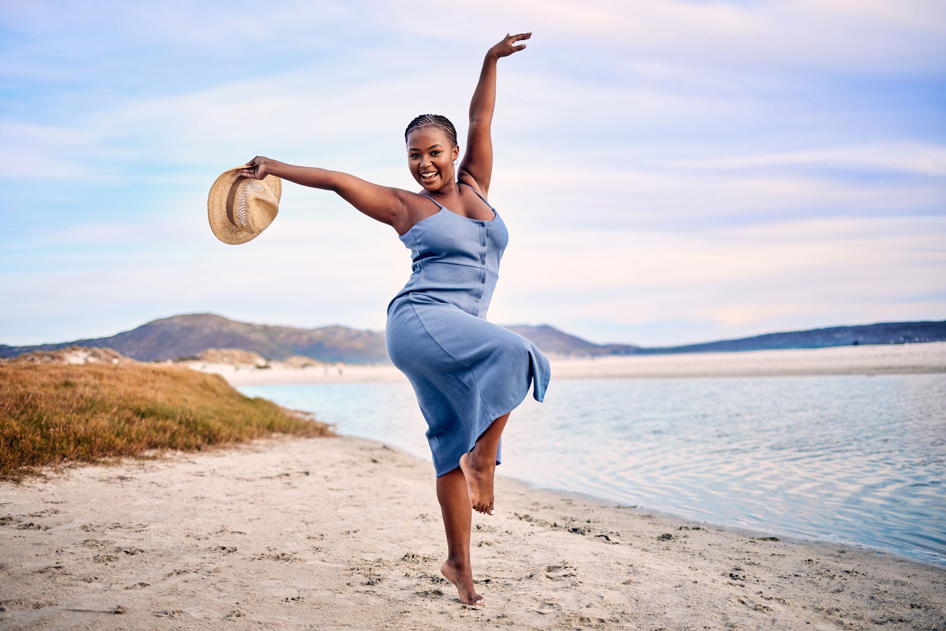 Portrait of an ecstatic  young woman enjoying her time at the beach